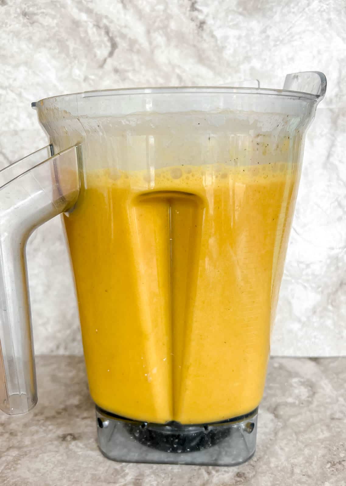 Healthy butternut squash soup in a blender after mixed.