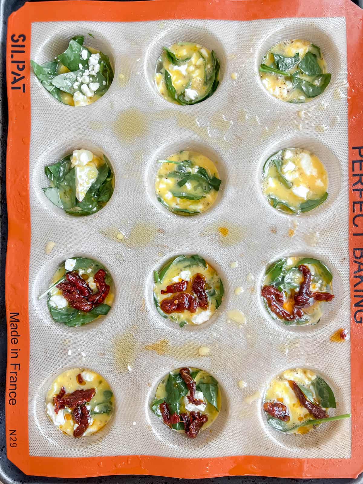 Egg mixture added to each muffin tin.