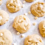 White chocolate chip cookies surrounded by white chocolate chips.