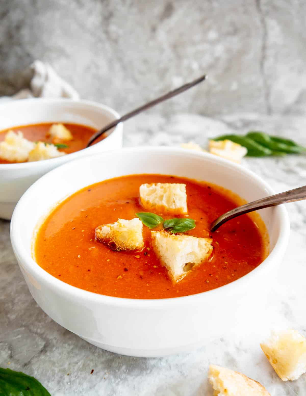 A bowl of tomato soup made from tomato sauce, topped in croutons.