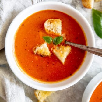 Creamy easy tomato soup in a bowl topped in croutons.