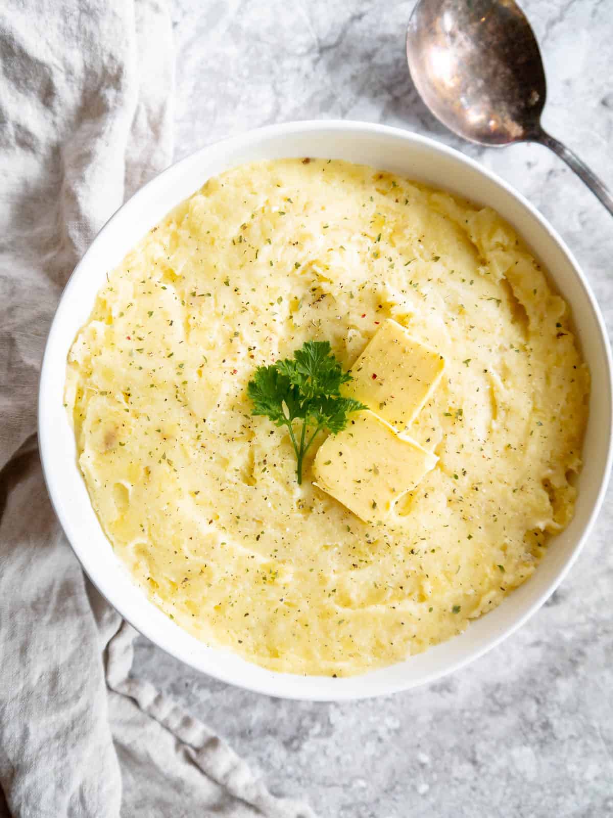 Smooth mashed potatoes with cottage cheese in a bowl.