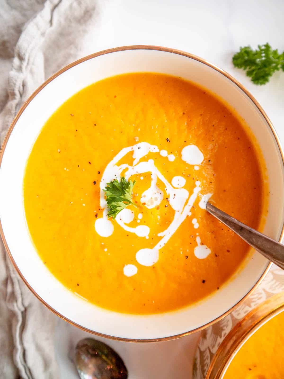 Butternut squash and carrot soup in a bowl.