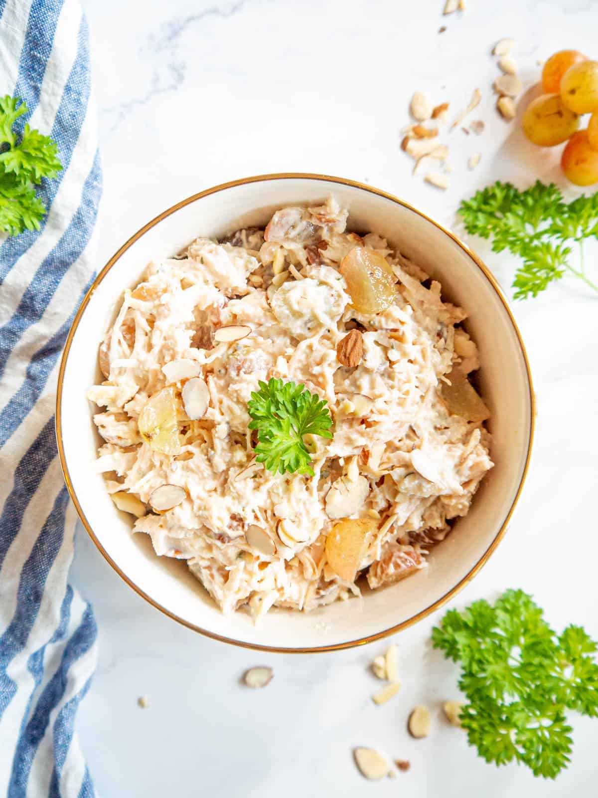 Chicken salad using canned chicken mixed with grapes and almonds in a bowl.