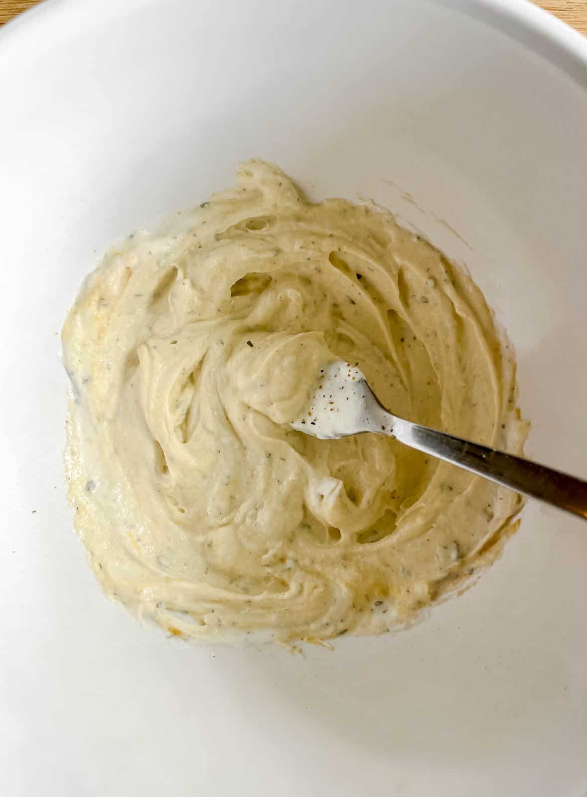 The greek yogurt sauce mixed in a bowl.