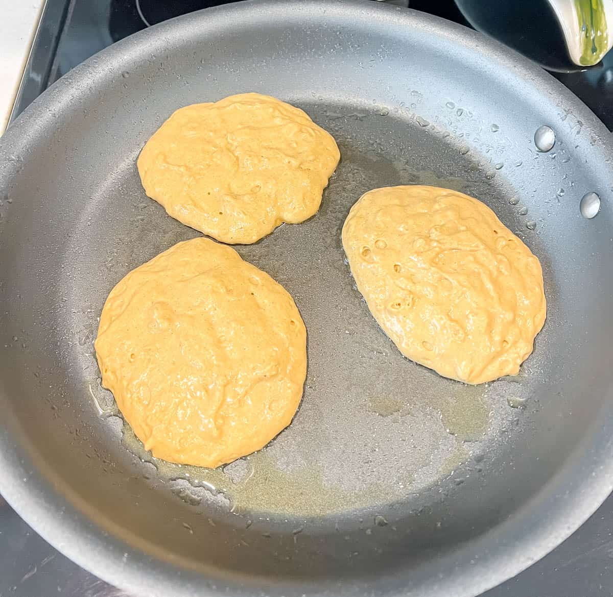 Healthy pumpkin pancakes on a pan.