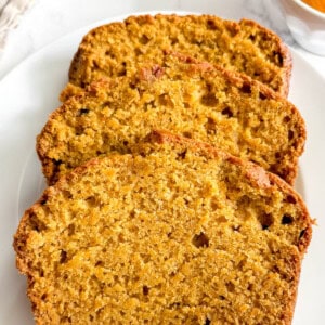 Slices of dairy-free pumpkin bread on a plate.