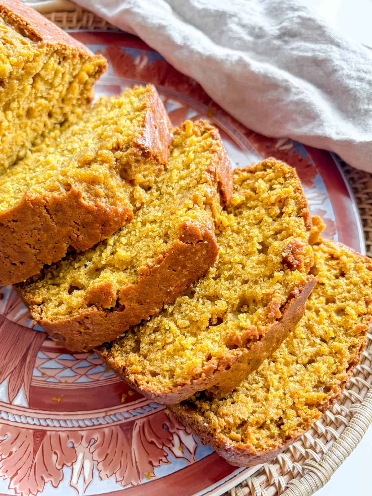 Slices of moist pumpkin bread on a plate.