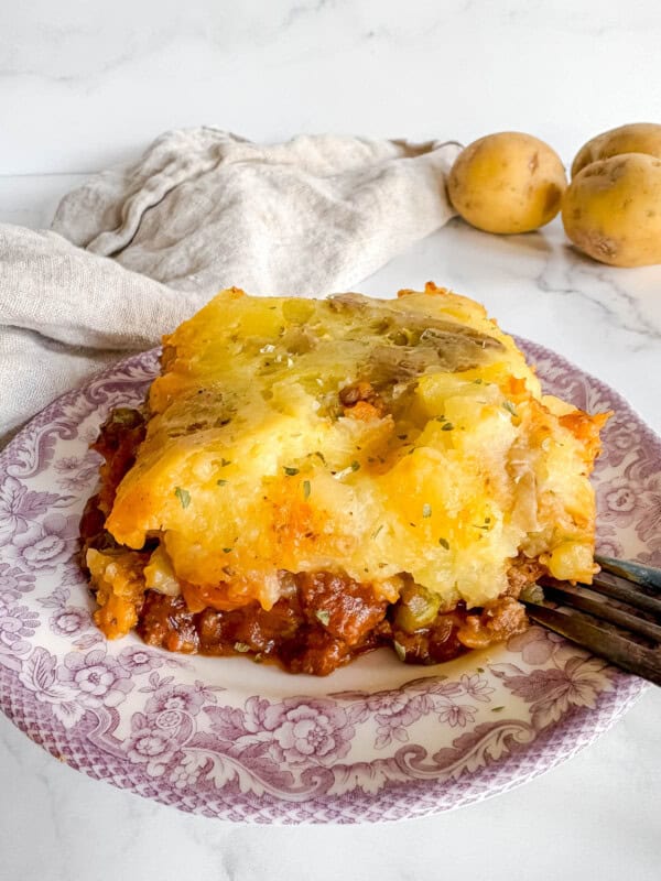 A slice of ground beef shepherd's pie on a plate.