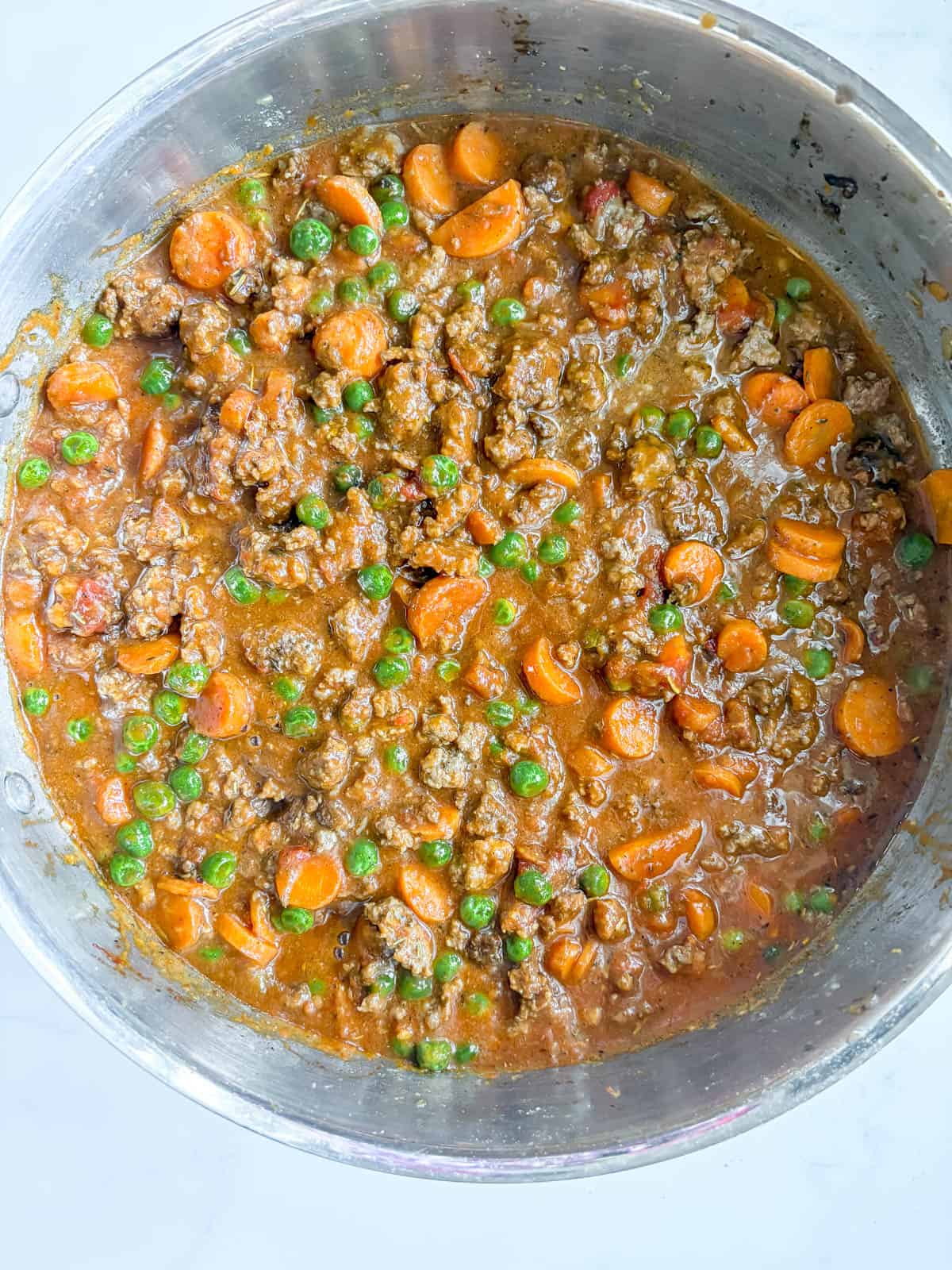 Strained tomatoes and chicken stock added to make the shepherd's pie gravy.