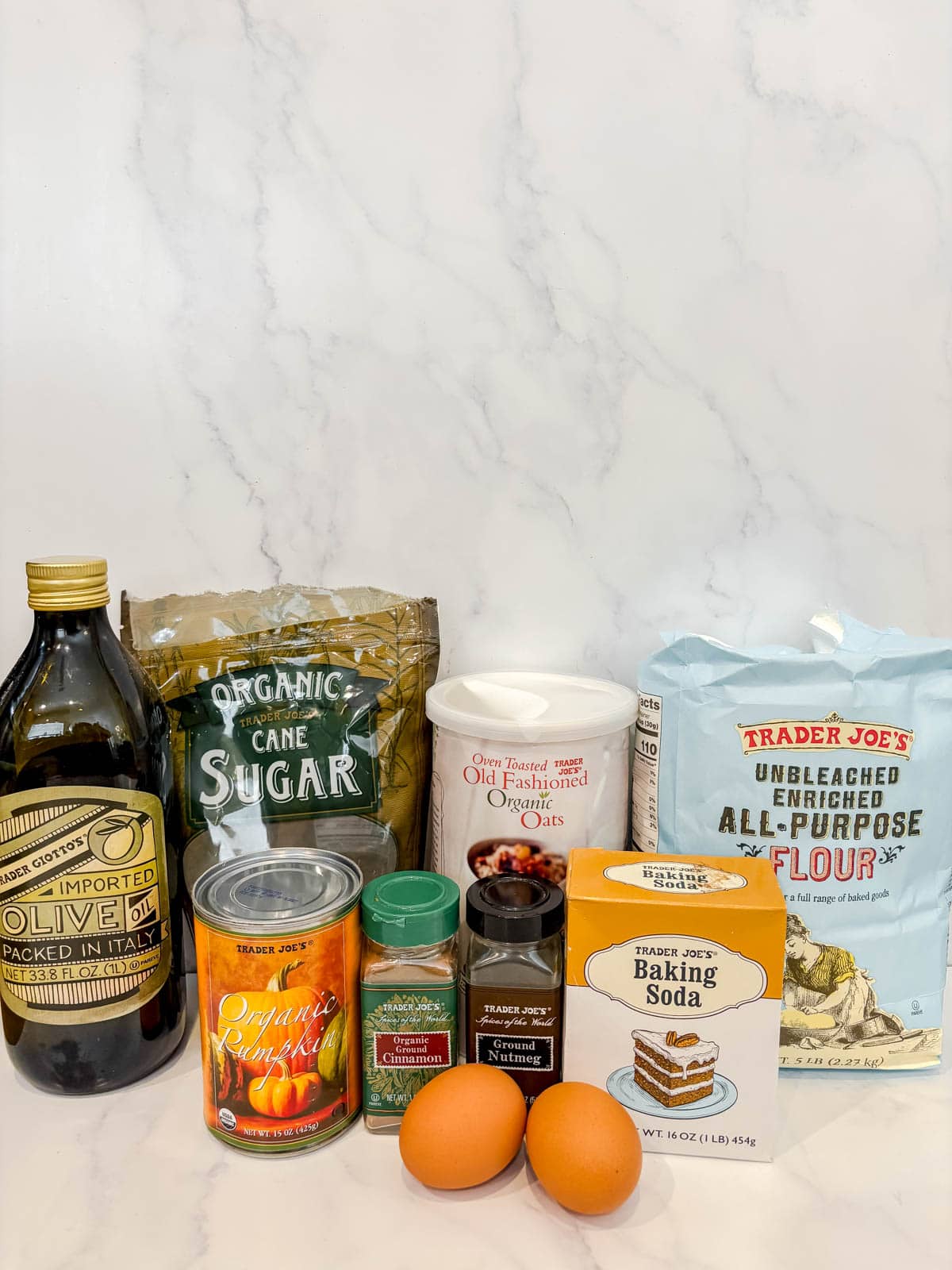 Ingredients needed to make pumpkin oat muffins.