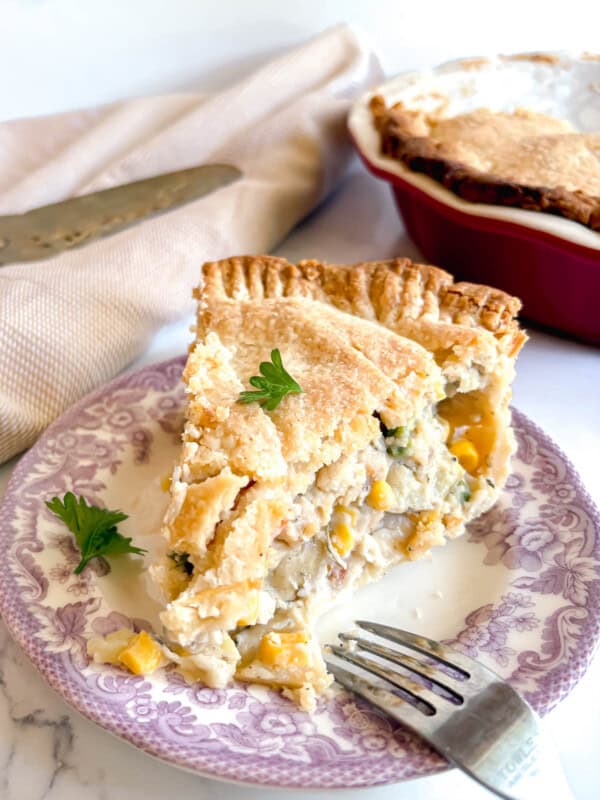 A slice of chicken pot pie made with store bought crust on a plate.