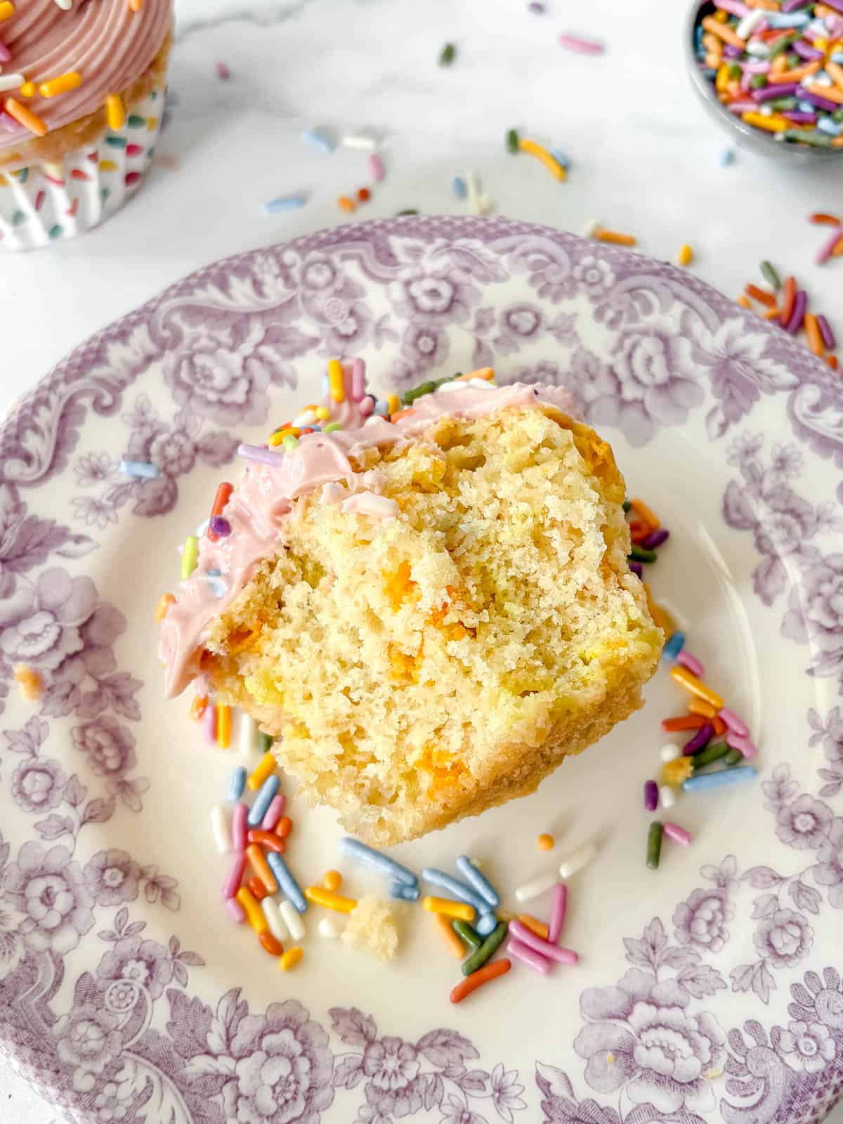 A homemade funfetti cupcake bitten into.