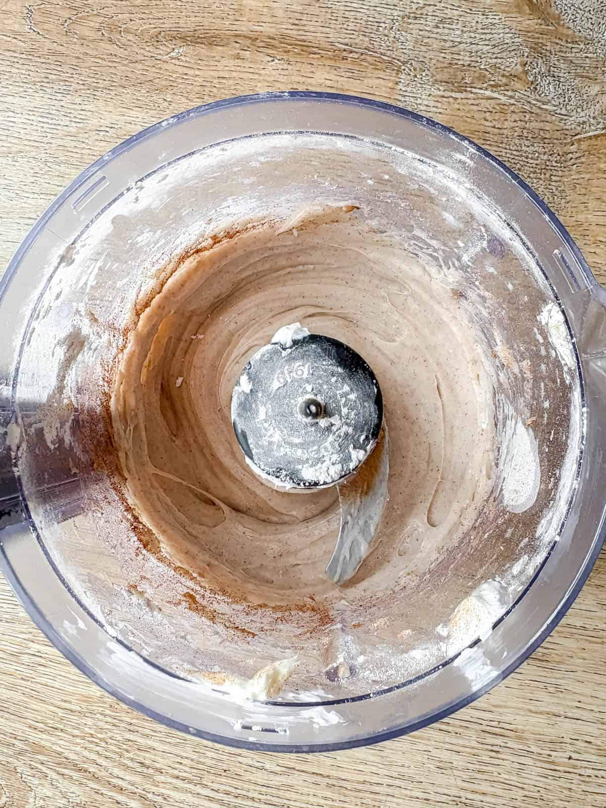 Cinnamon cream cheese frosting in a food processor.