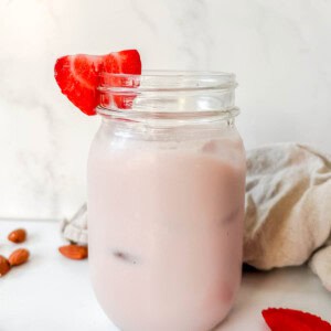 Strawberry almond milk in a mason jar.