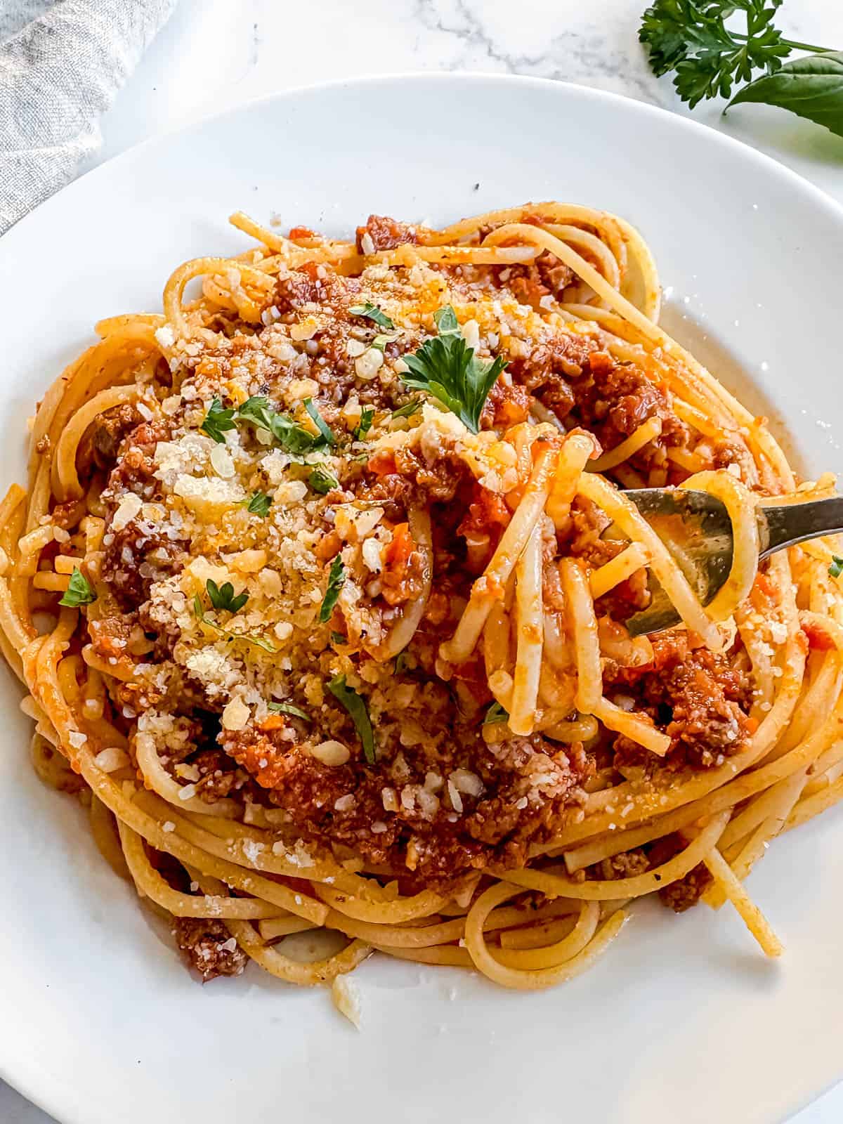 Spaghetti covered in slow cooker spaghetti sauce with ground beef.