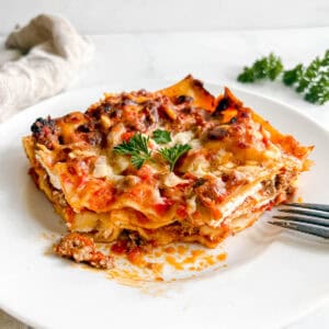 A slice of no boil noodles lasagna made with greek yogurt on a plate.