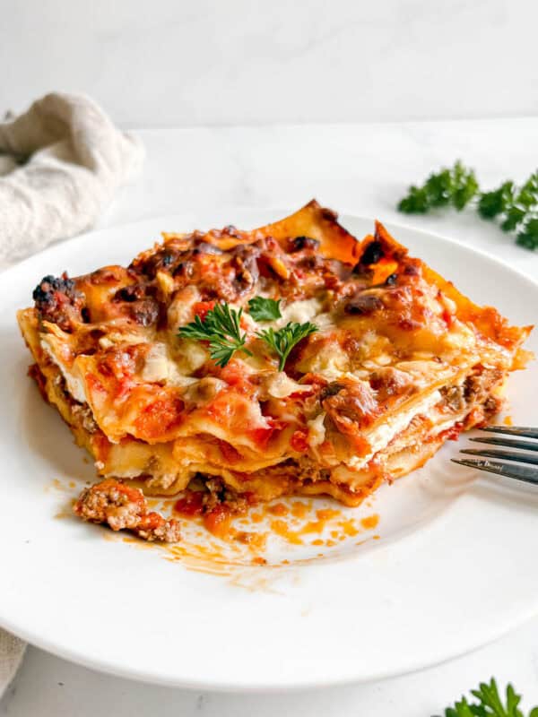 A slice of no boil noodles lasagna made with greek yogurt on a plate.