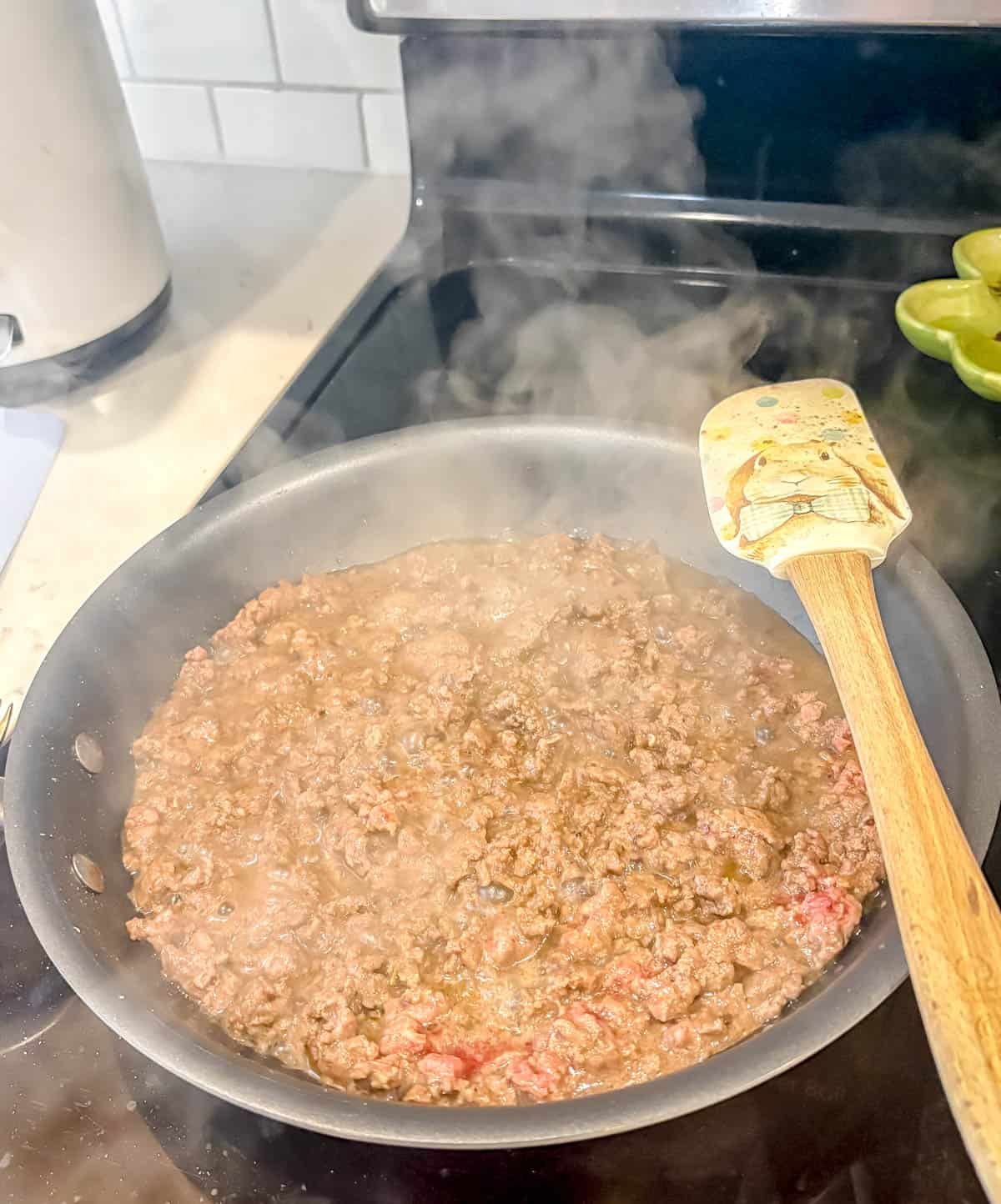 Ground beef cooking in a pan.