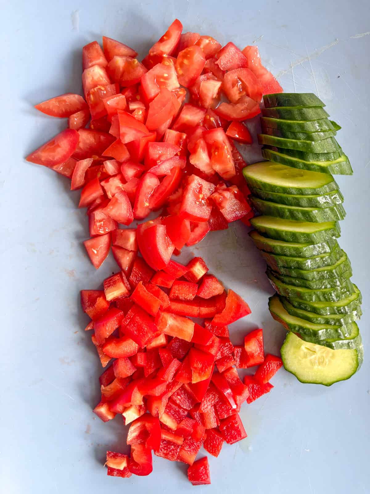 Diced and sliced fresh tomato, red pepper and cucumbers.