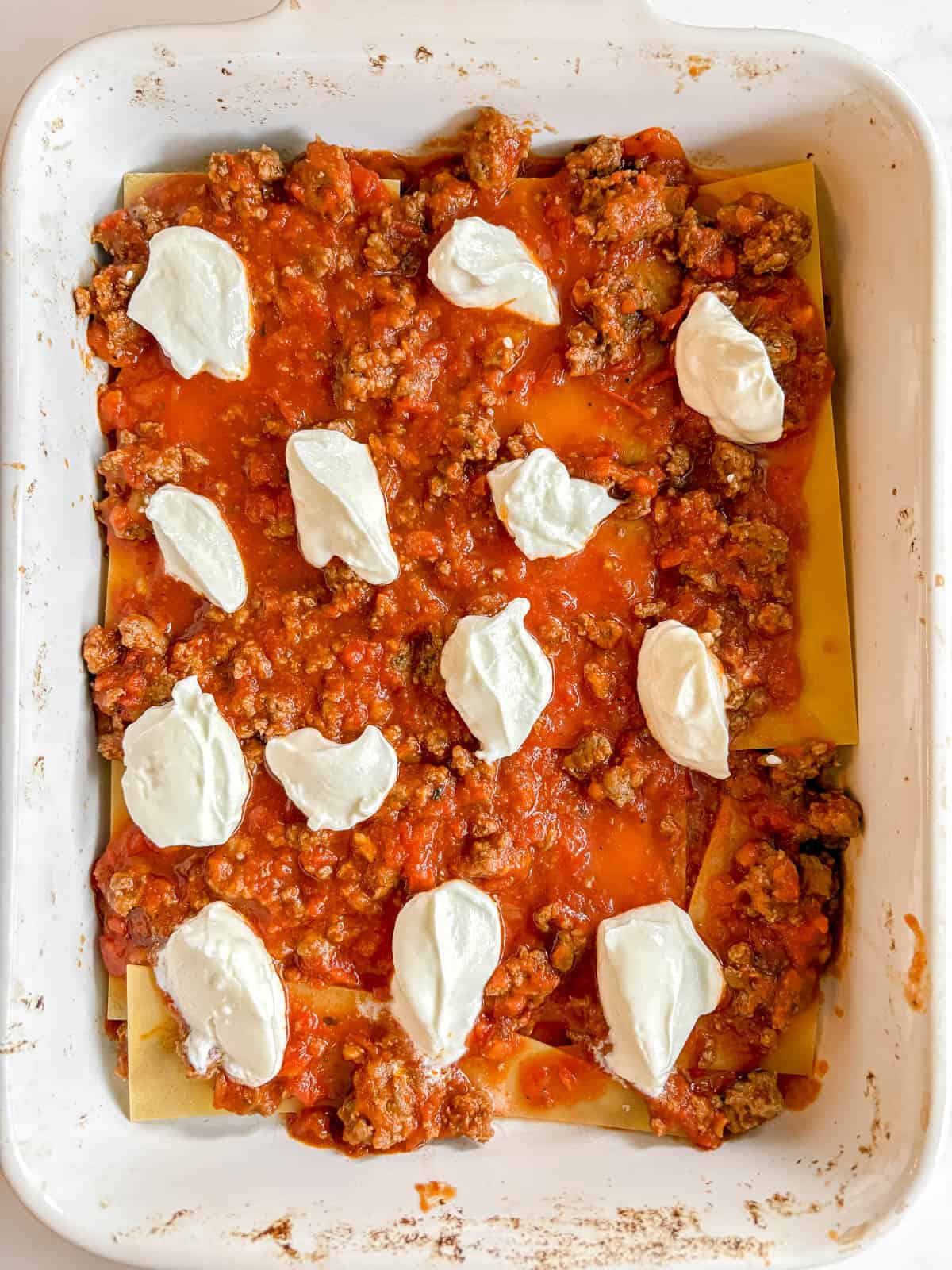 Lasagna layer where greek yogurt is added to the meat sauce.