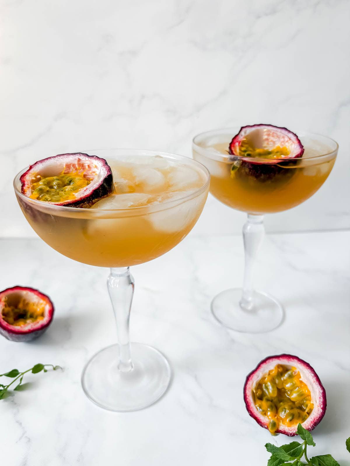 Passion fruit gin cocktails garnished with passion fruit.