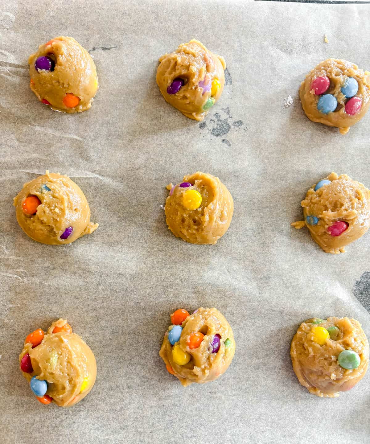 Chocolate chip cookies on a pan before baking.