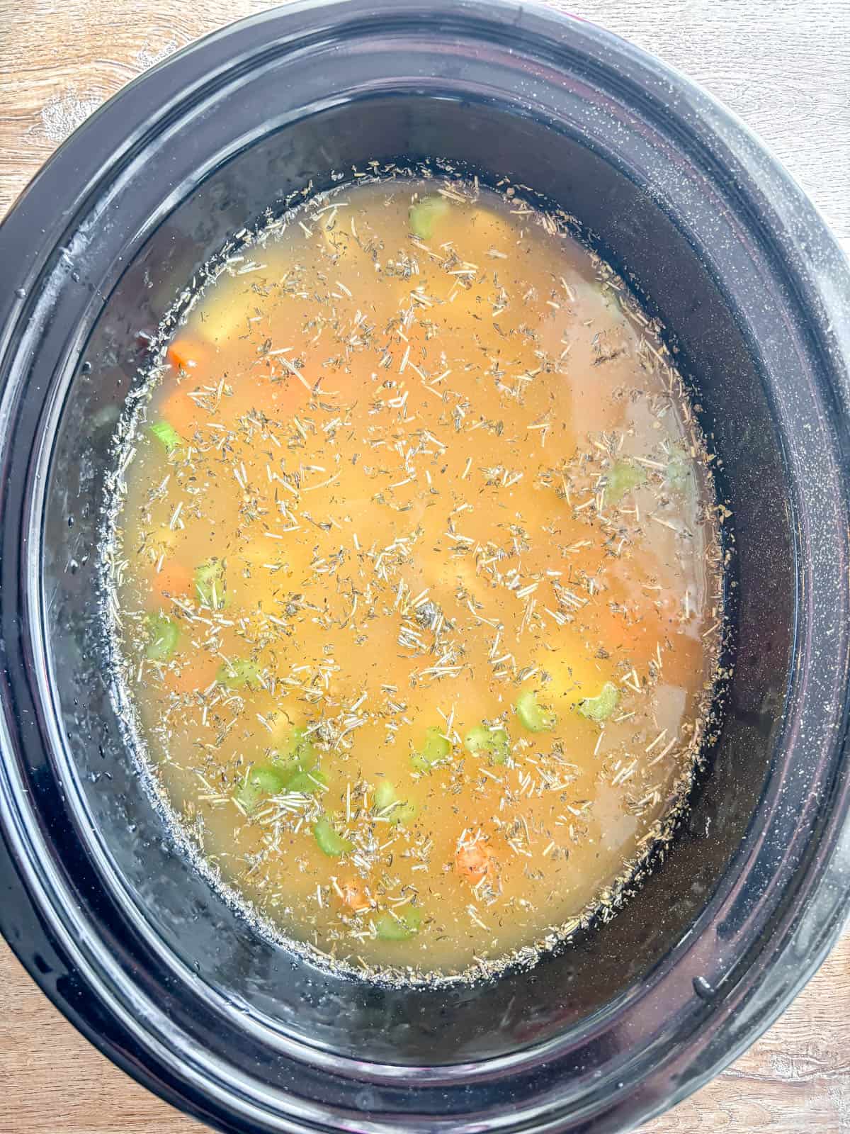 Chicken potato soup in crockpot before cooking.