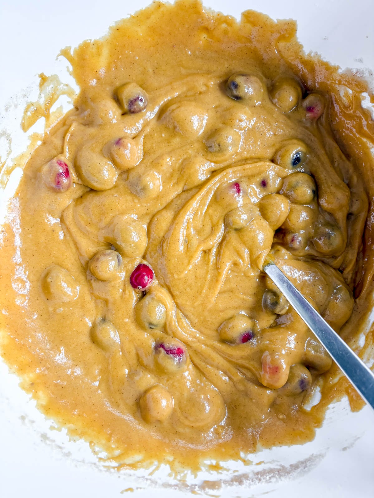 Pumpkin cranberry batter in a bowl.